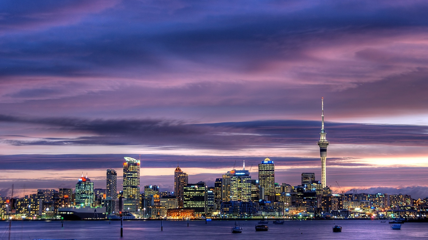 City Skyline Under Cloudy Sky During Night Time. Wallpaper in 1366x768 Resolution
