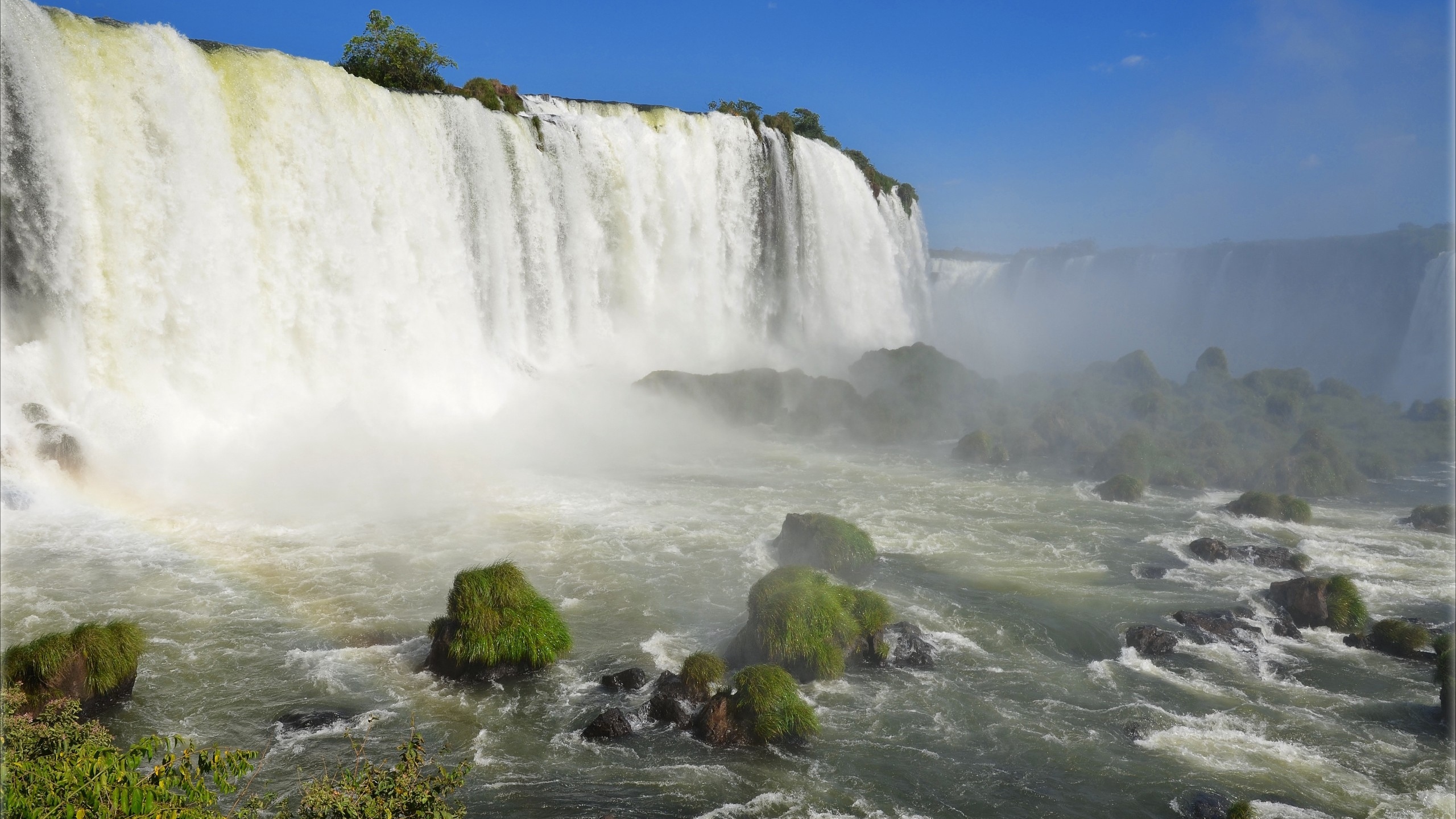 Waterfalls on Green Grass Field Under Blue Sky During Daytime. Wallpaper in 2560x1440 Resolution
