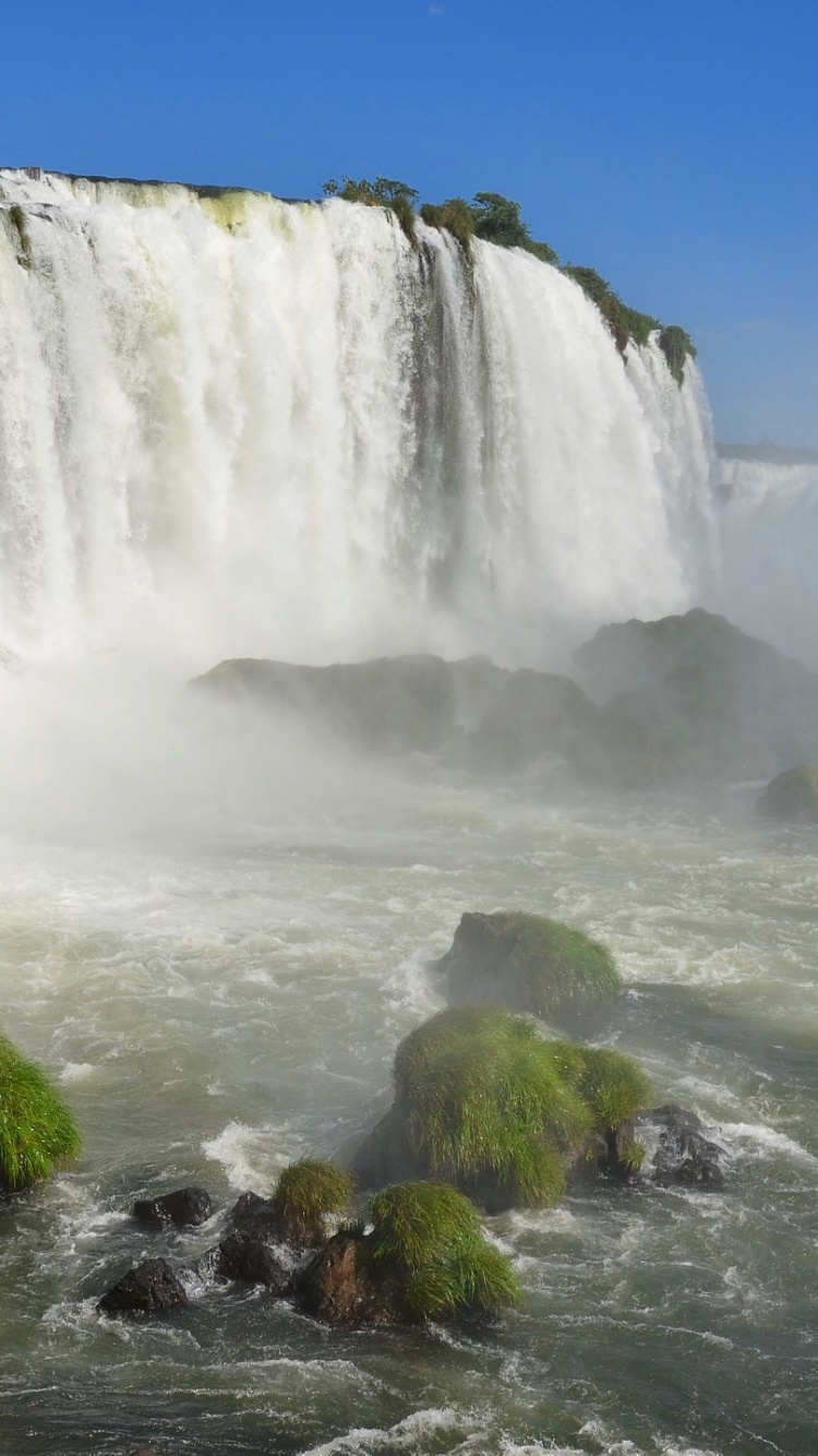 Waterfalls on Green Grass Field Under Blue Sky During Daytime. Wallpaper in 750x1334 Resolution