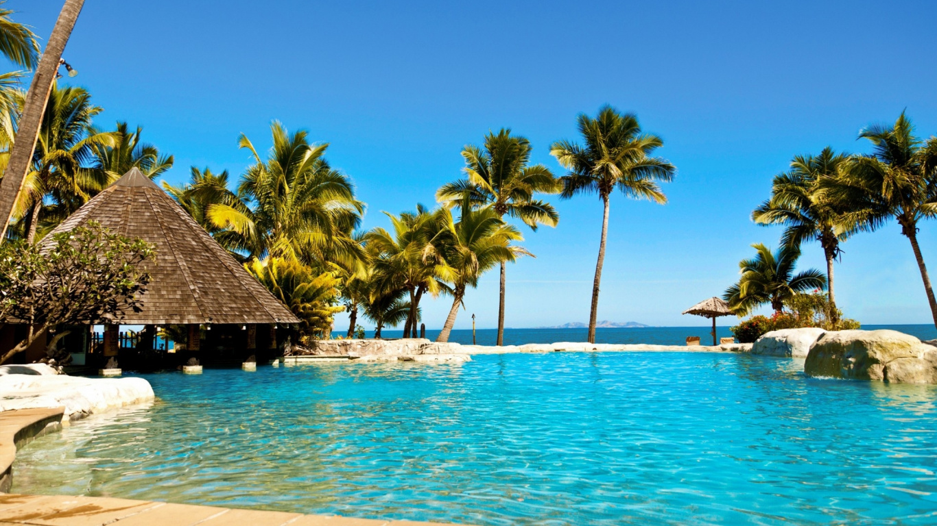 Brown Wooden Beach House Near Palm Trees During Daytime. Wallpaper in 1366x768 Resolution