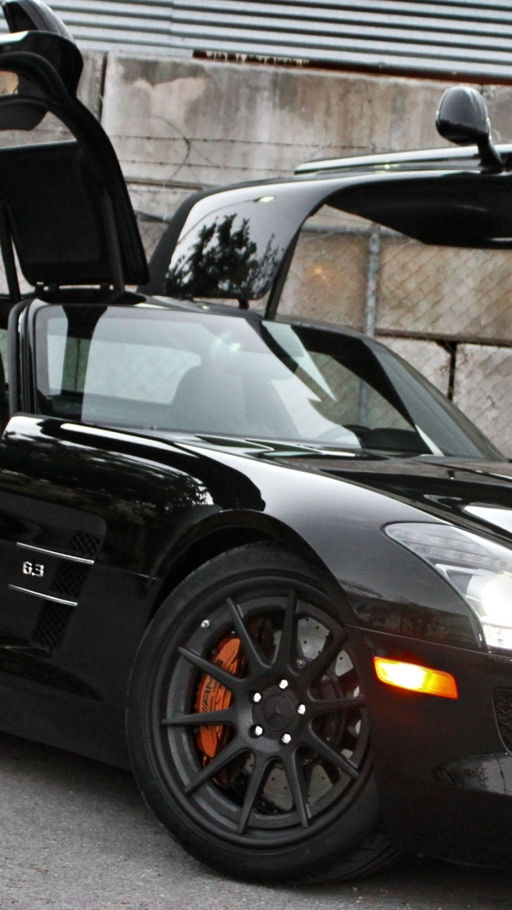 Black Porsche 911 Parked Near Brown Brick Wall. Wallpaper in 720x1280 Resolution