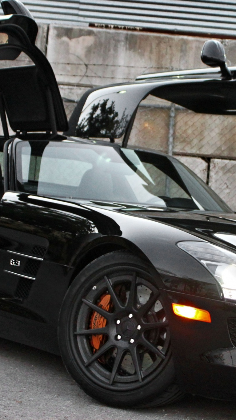 Black Porsche 911 Parked Near Brown Brick Wall. Wallpaper in 750x1334 Resolution