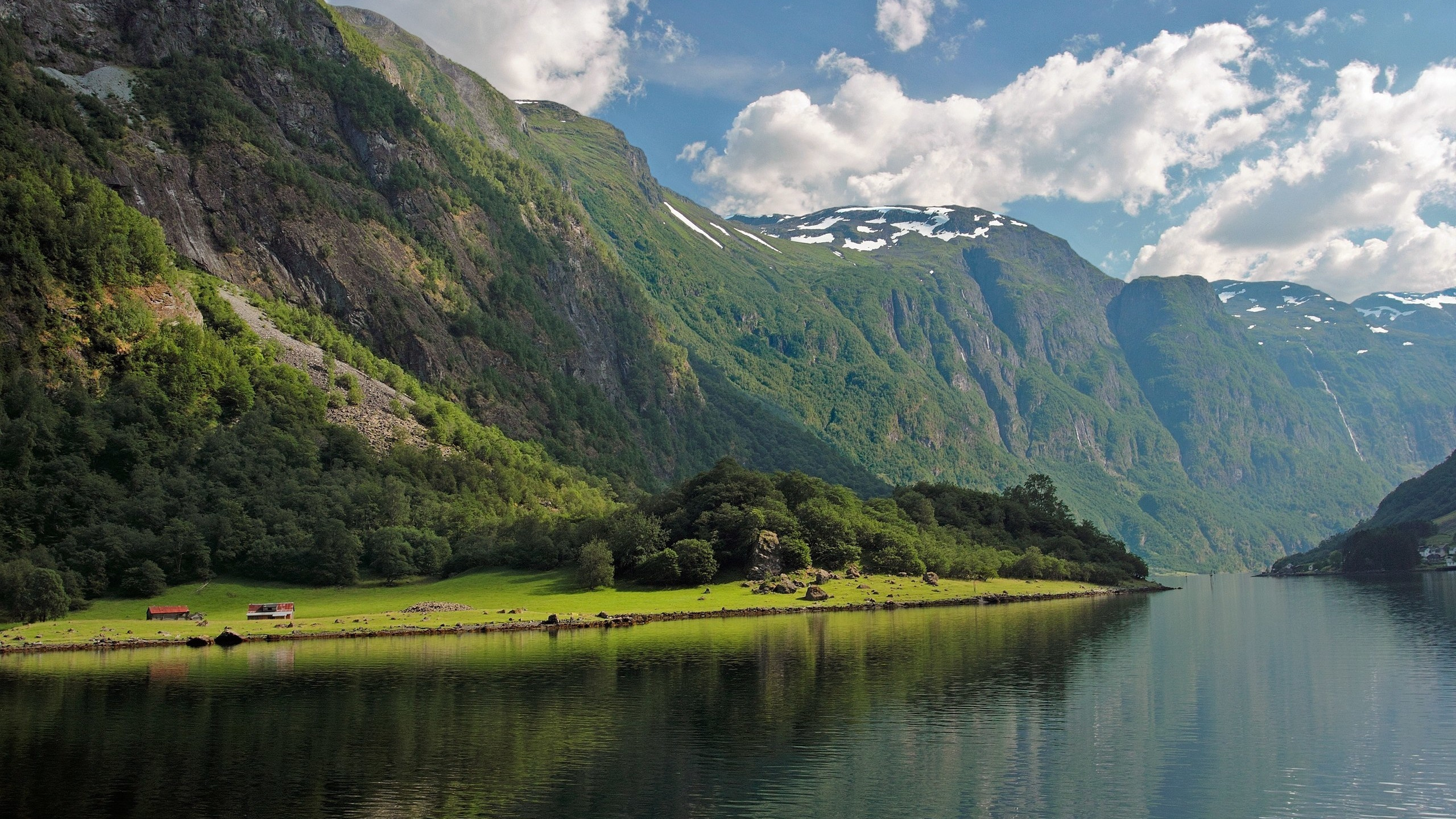 Green Mountains Beside Lake Under Blue Sky During Daytime. Wallpaper in 2560x1440 Resolution