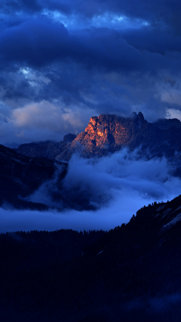 Brown and Black Mountains Under Gray Clouds. Wallpaper in 750x1334 Resolution