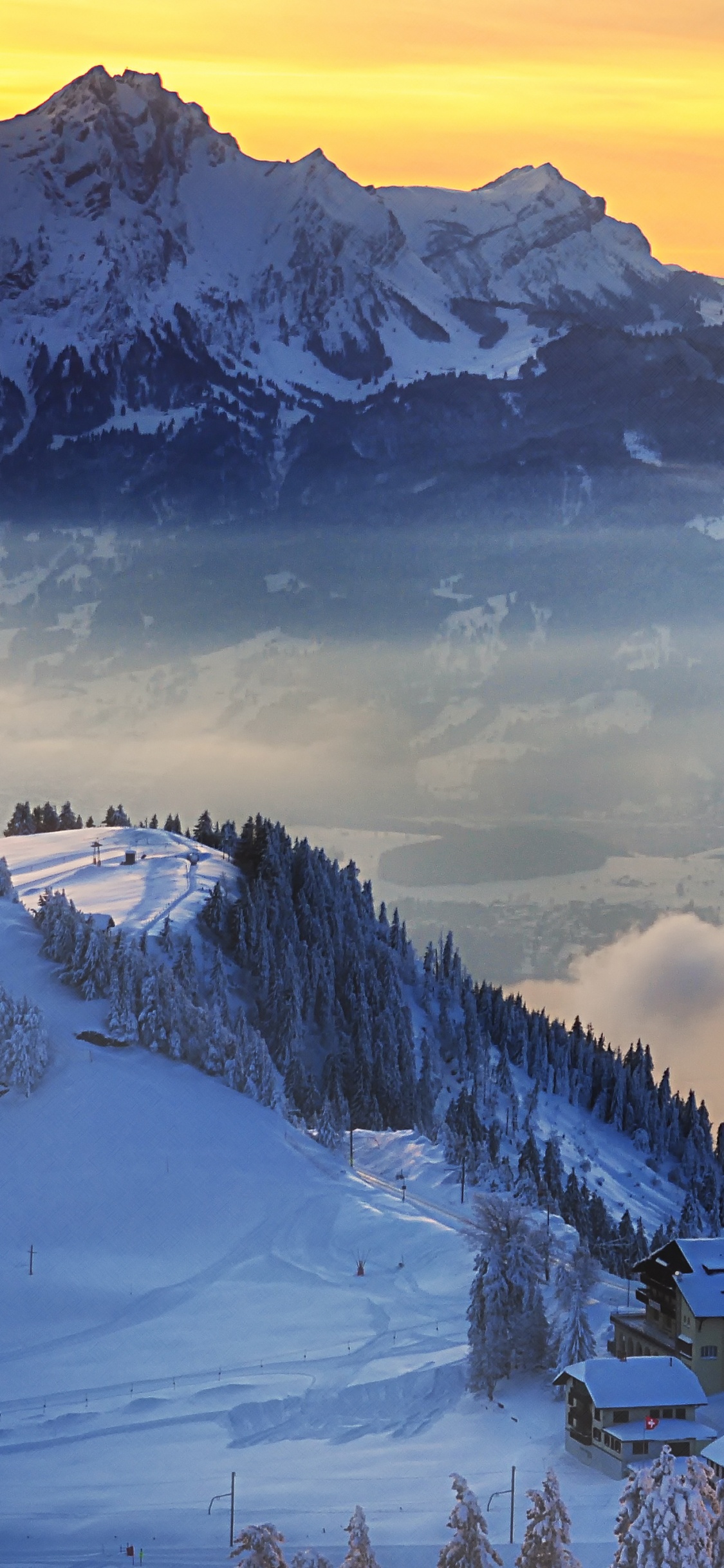 Snow Covered Mountain Under Cloudy Sky During Daytime. Wallpaper in 1125x2436 Resolution