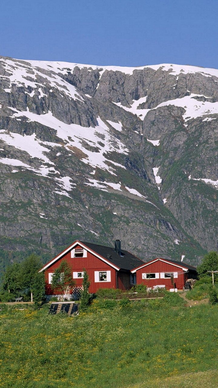 Red and White House Near Snow Covered Mountain During Daytime. Wallpaper in 720x1280 Resolution