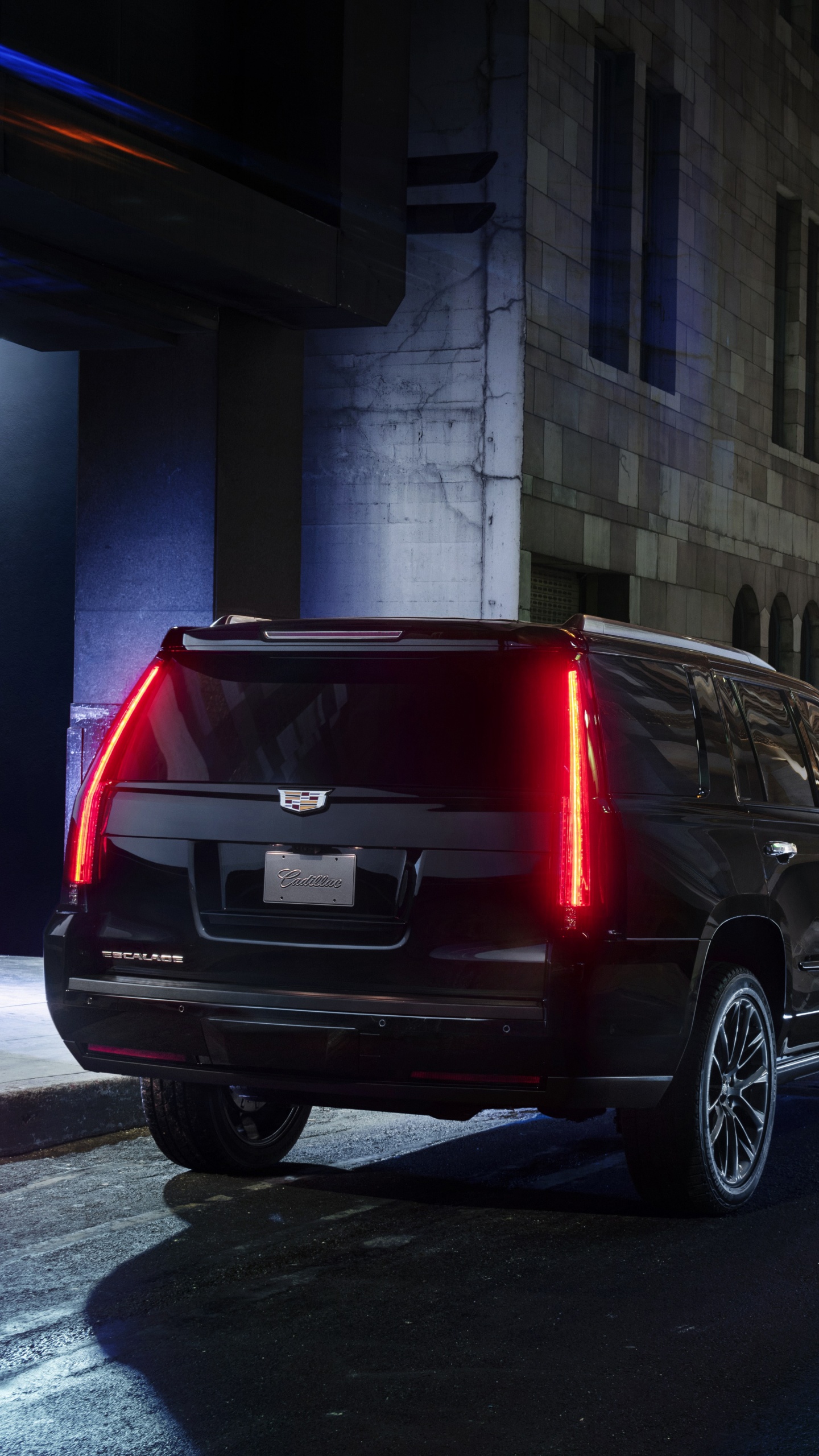 Black Suv Parked Beside Red Van. Wallpaper in 1440x2560 Resolution