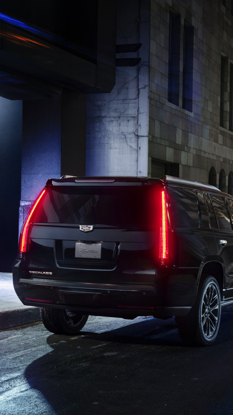 Black Suv Parked Beside Red Van. Wallpaper in 750x1334 Resolution