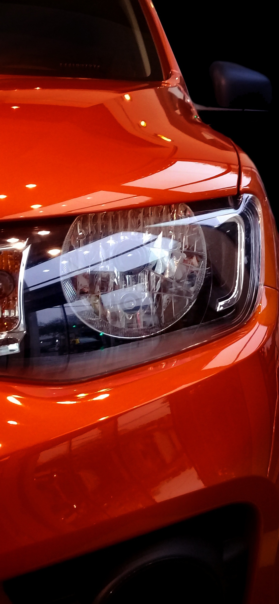 Orange Car With White Lights. Wallpaper in 1125x2436 Resolution