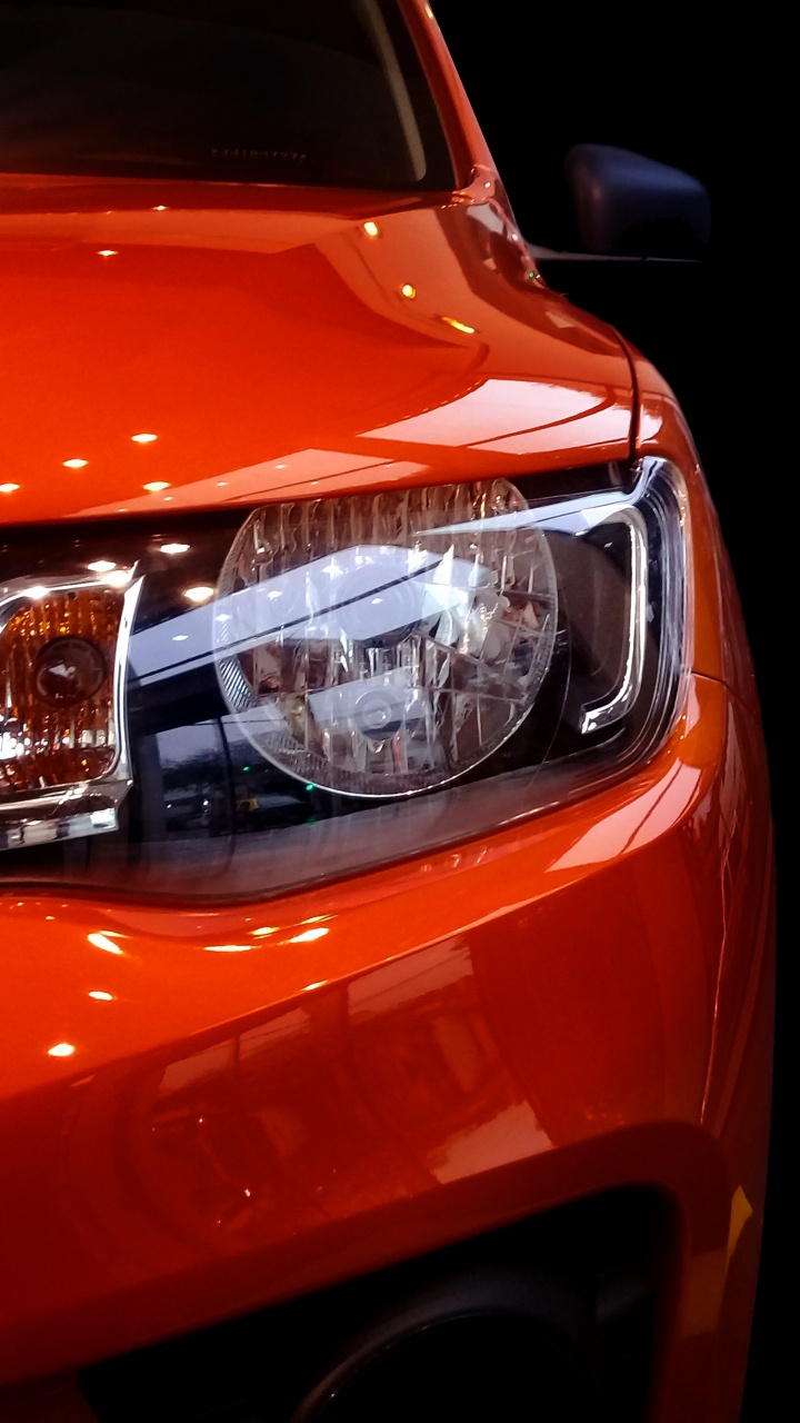 Orange Car With White Lights. Wallpaper in 720x1280 Resolution