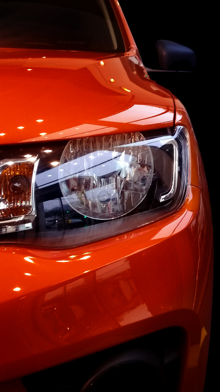 Orange Car With White Lights. Wallpaper in 750x1334 Resolution