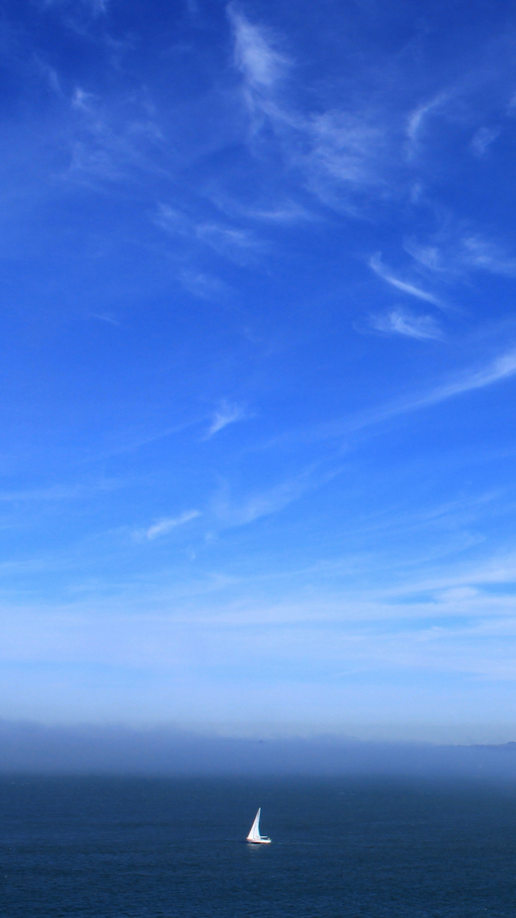 Person in Black Shirt Standing on Seashore During Daytime. Wallpaper in 750x1334 Resolution