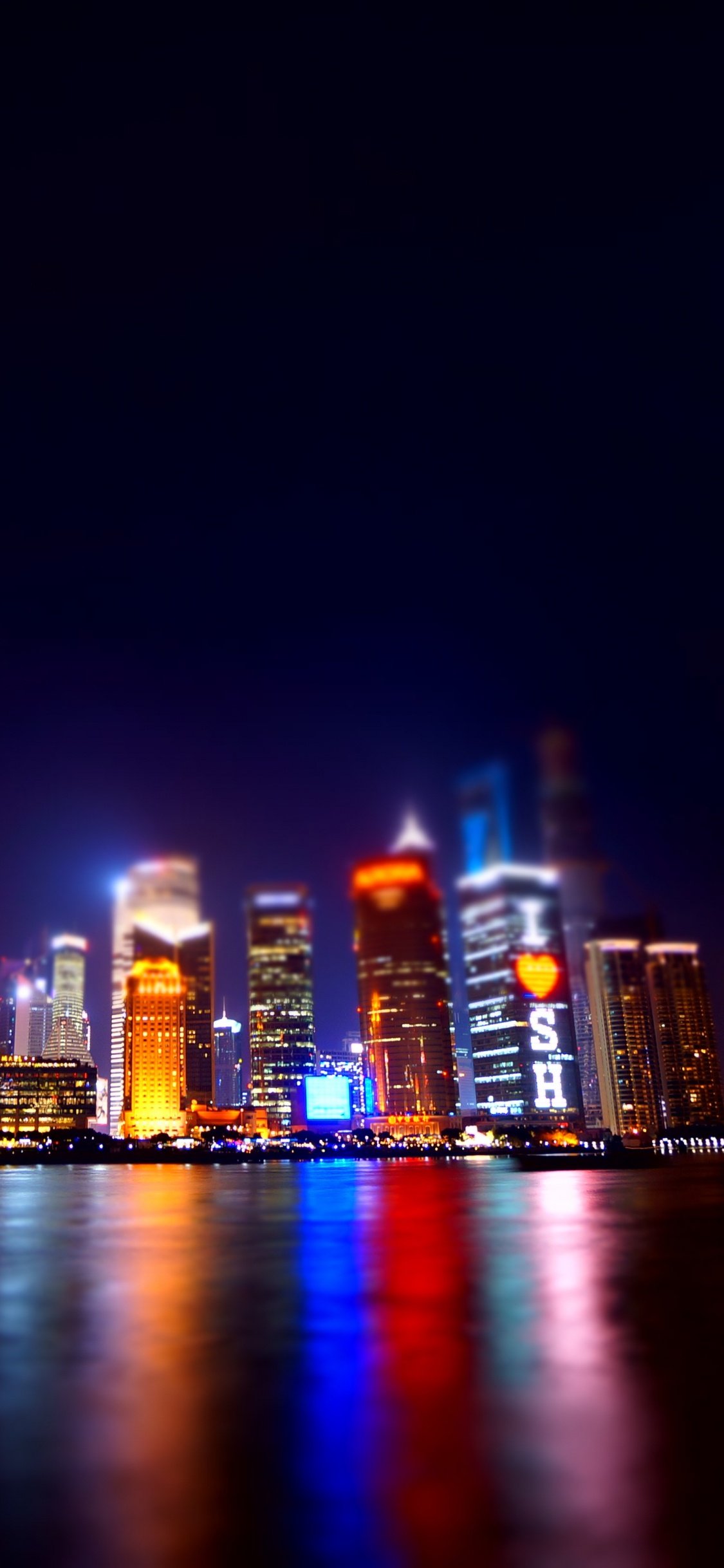 City Skyline During Night Time. Wallpaper in 1125x2436 Resolution