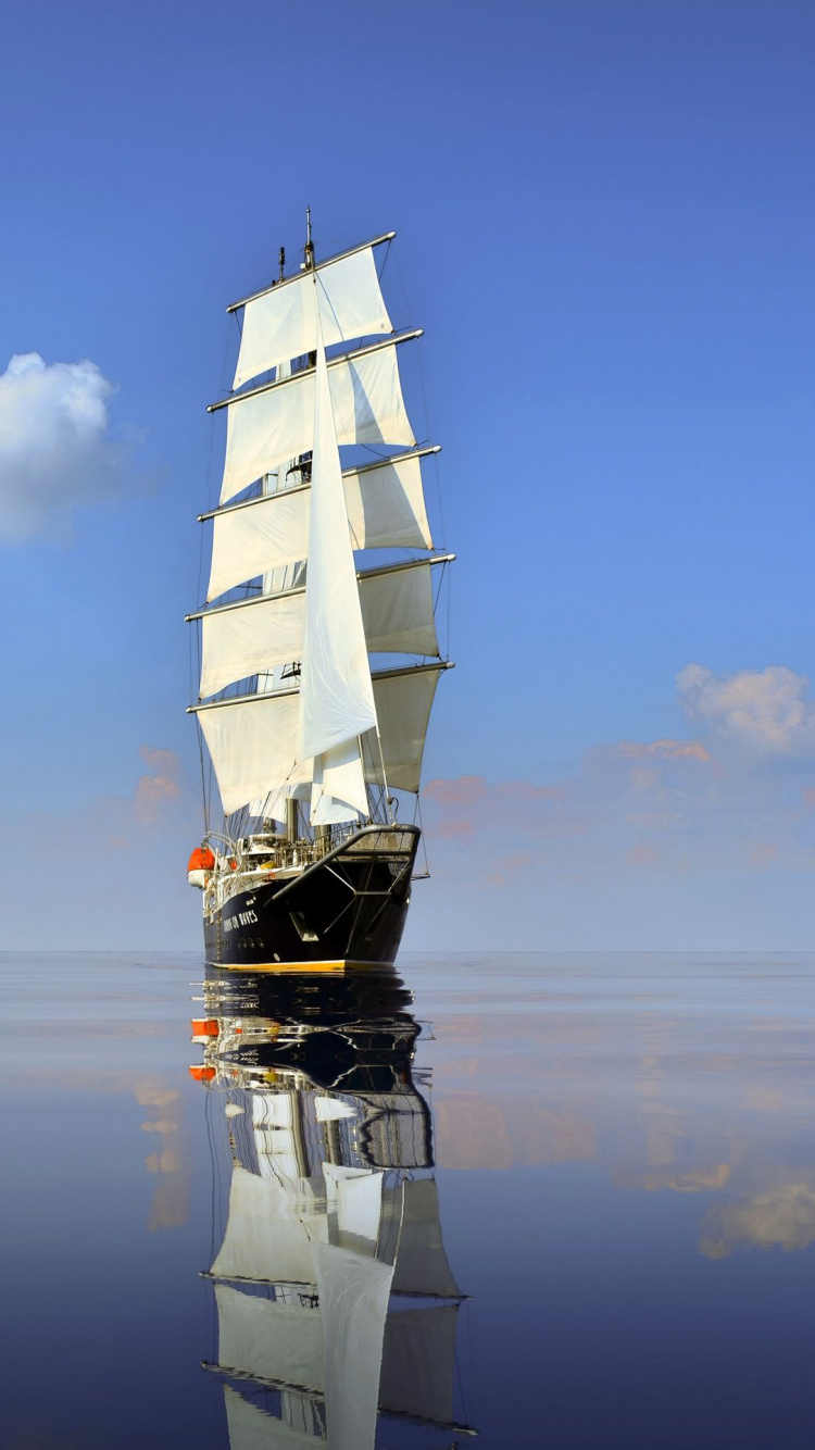 Black and White Sail Ship on Sea Under Blue Sky During Daytime. Wallpaper in 750x1334 Resolution