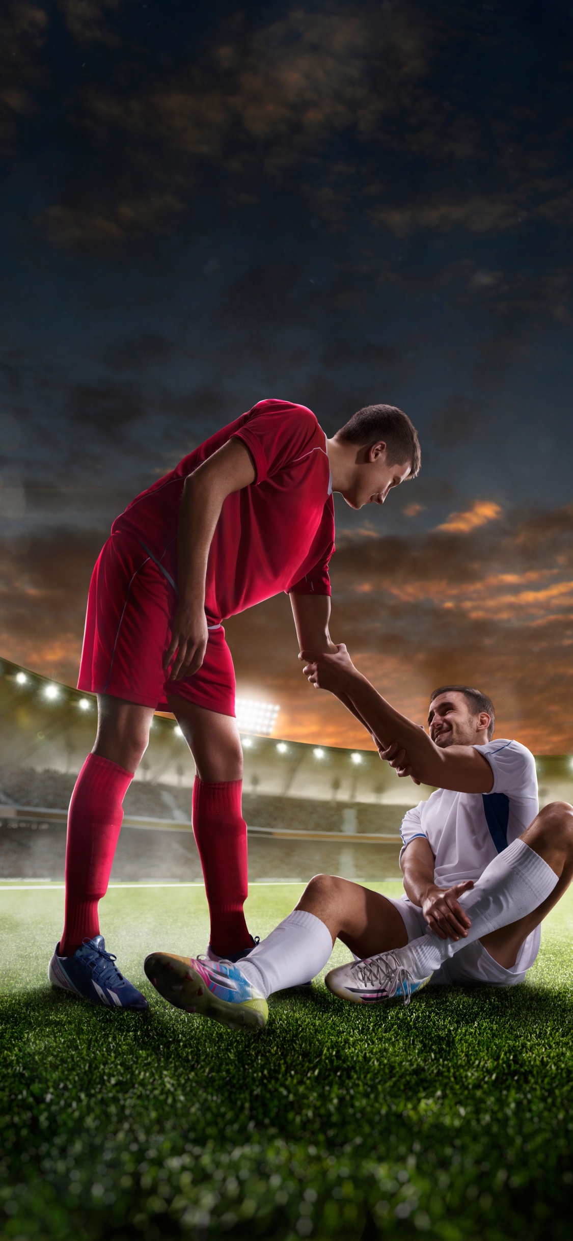 Man in Red Shirt and White Pants Playing Soccer. Wallpaper in 1125x2436 Resolution