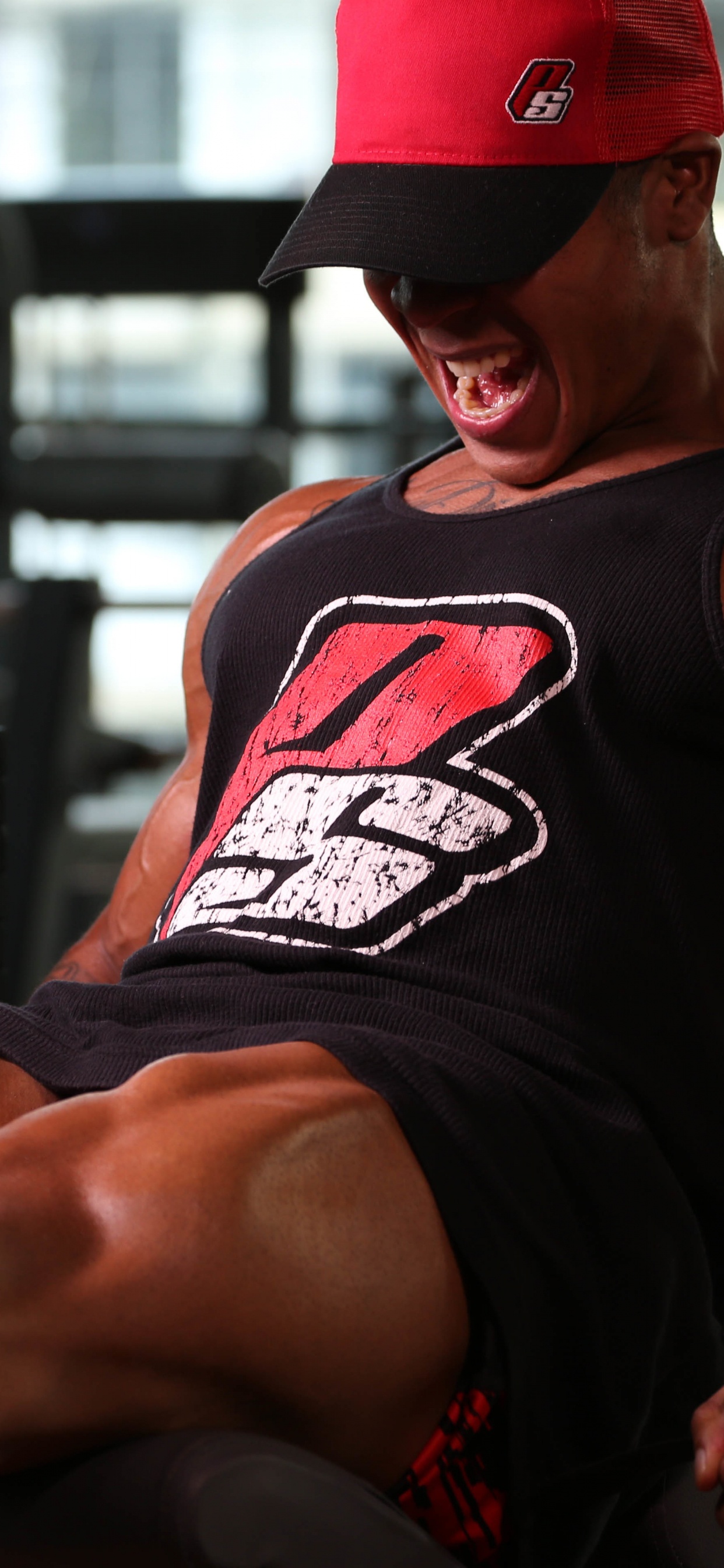 Man in Black Tank Top and Red Fitted Cap. Wallpaper in 1242x2688 Resolution