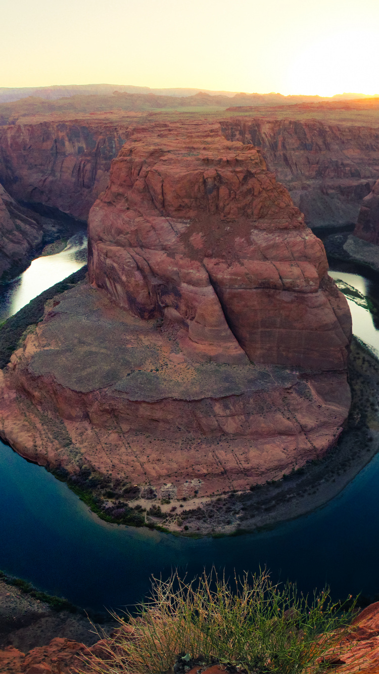 Brown Rock Formation Near Blue Lake During Daytime. Wallpaper in 750x1334 Resolution