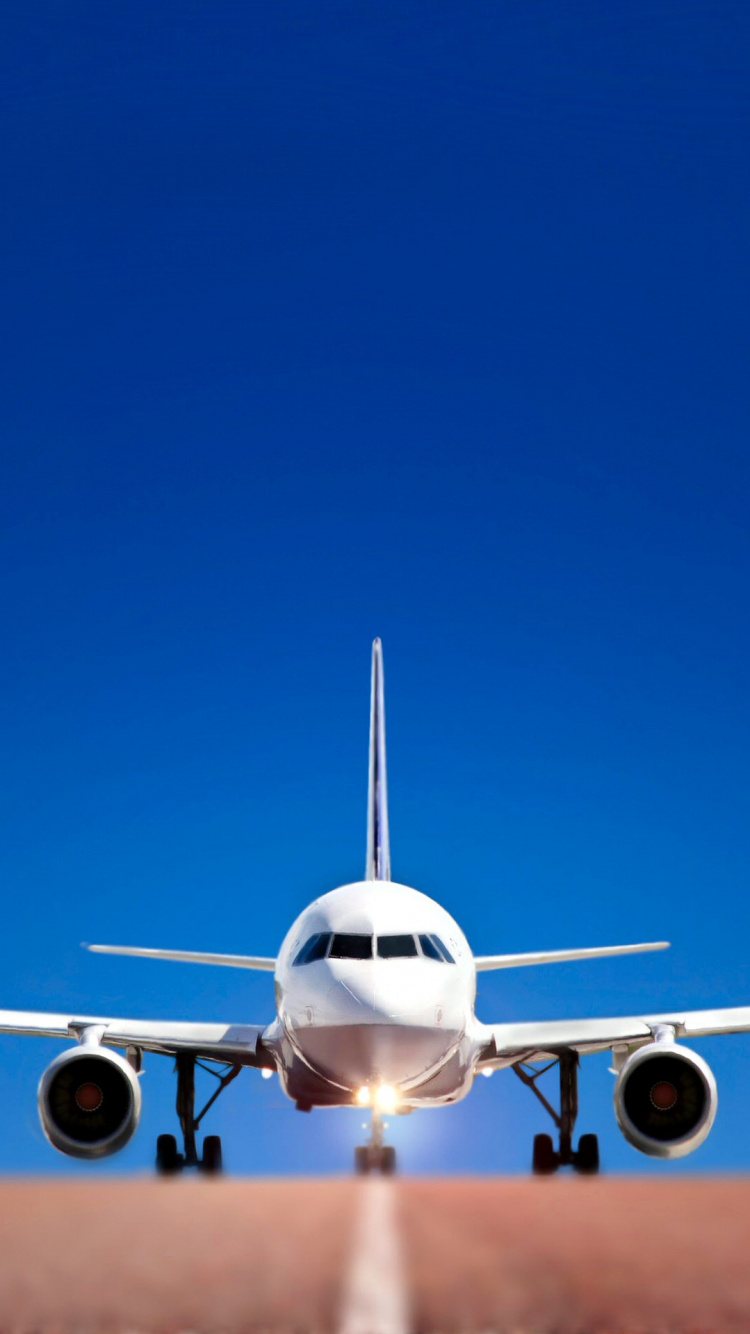 Avión Blanco en el Aire Durante el Día. Wallpaper in 750x1334 Resolution