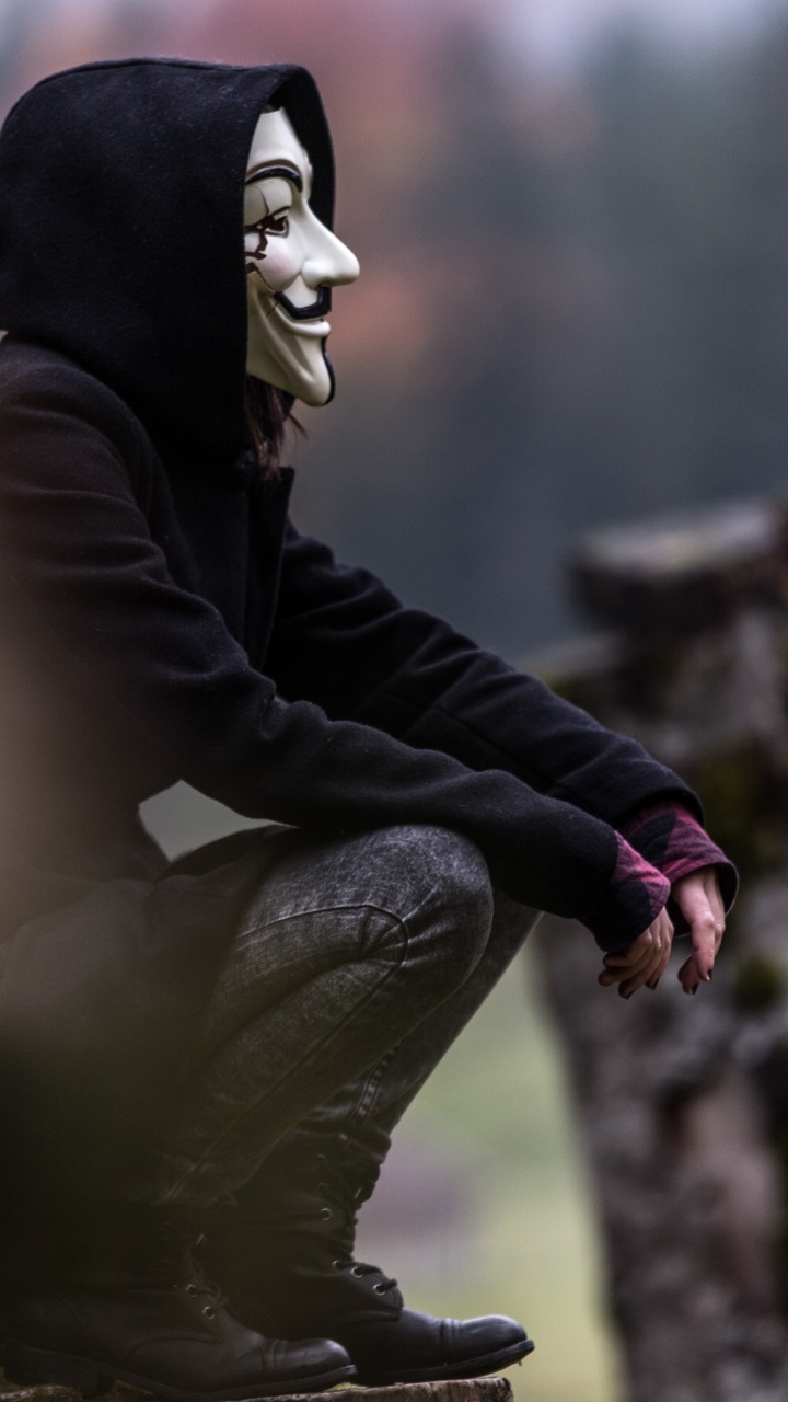 Person in Black and White Mask and Black Jacket Sitting on Rock. Wallpaper in 720x1280 Resolution