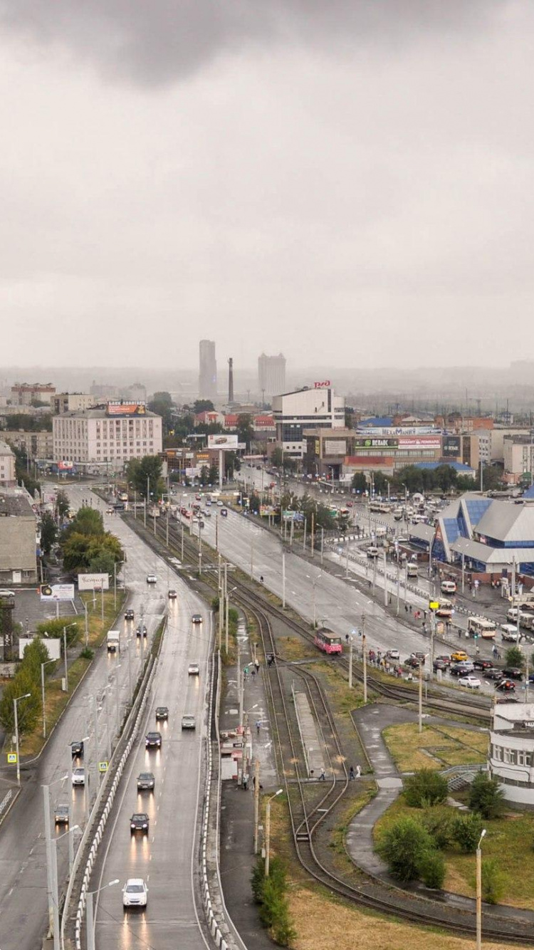 Cars on Road Near Buildings During Daytime. Wallpaper in 750x1334 Resolution