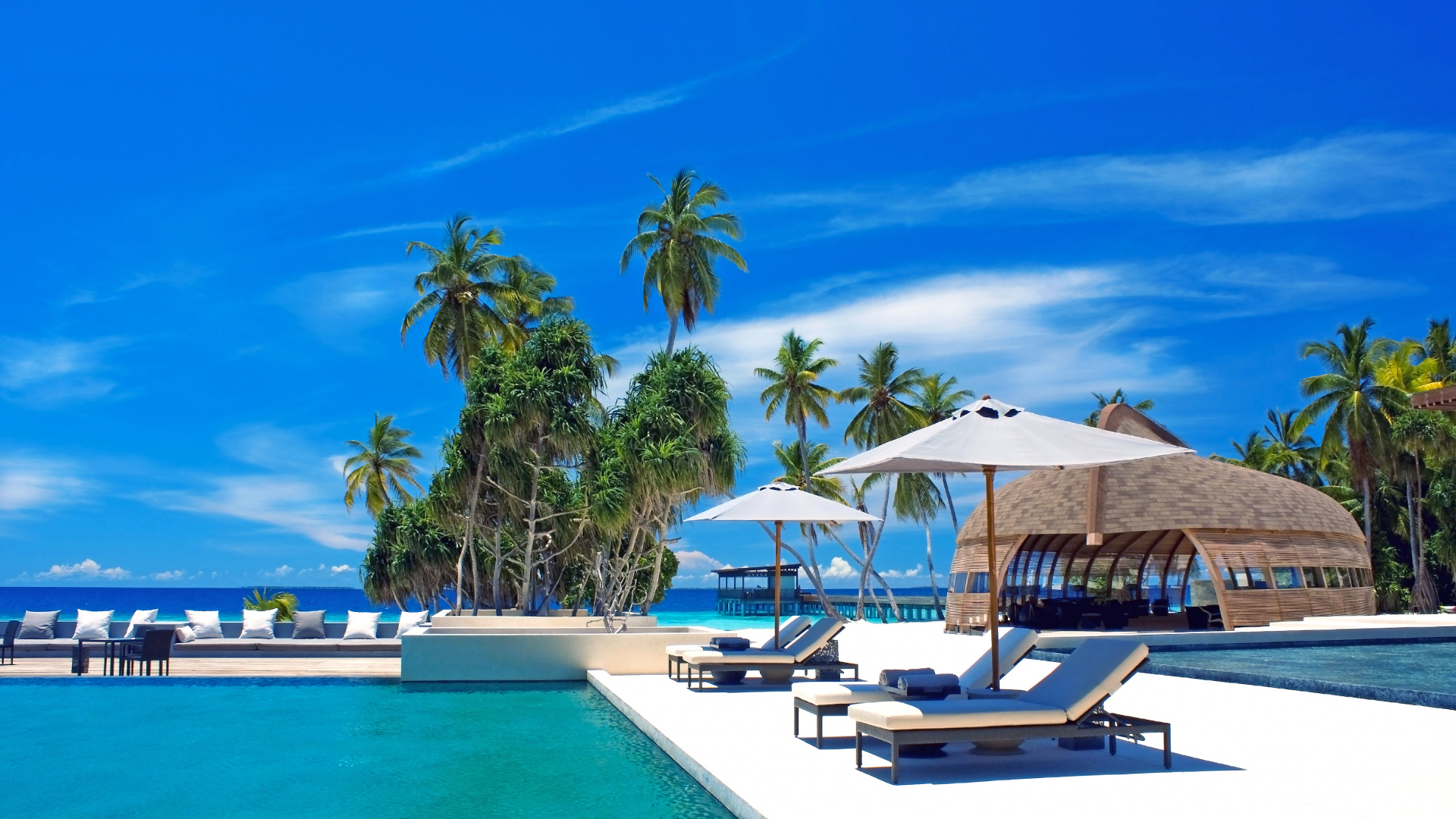 White and Brown Beach Umbrellas on Blue Body of Water During Daytime. Wallpaper in 1920x1080 Resolution