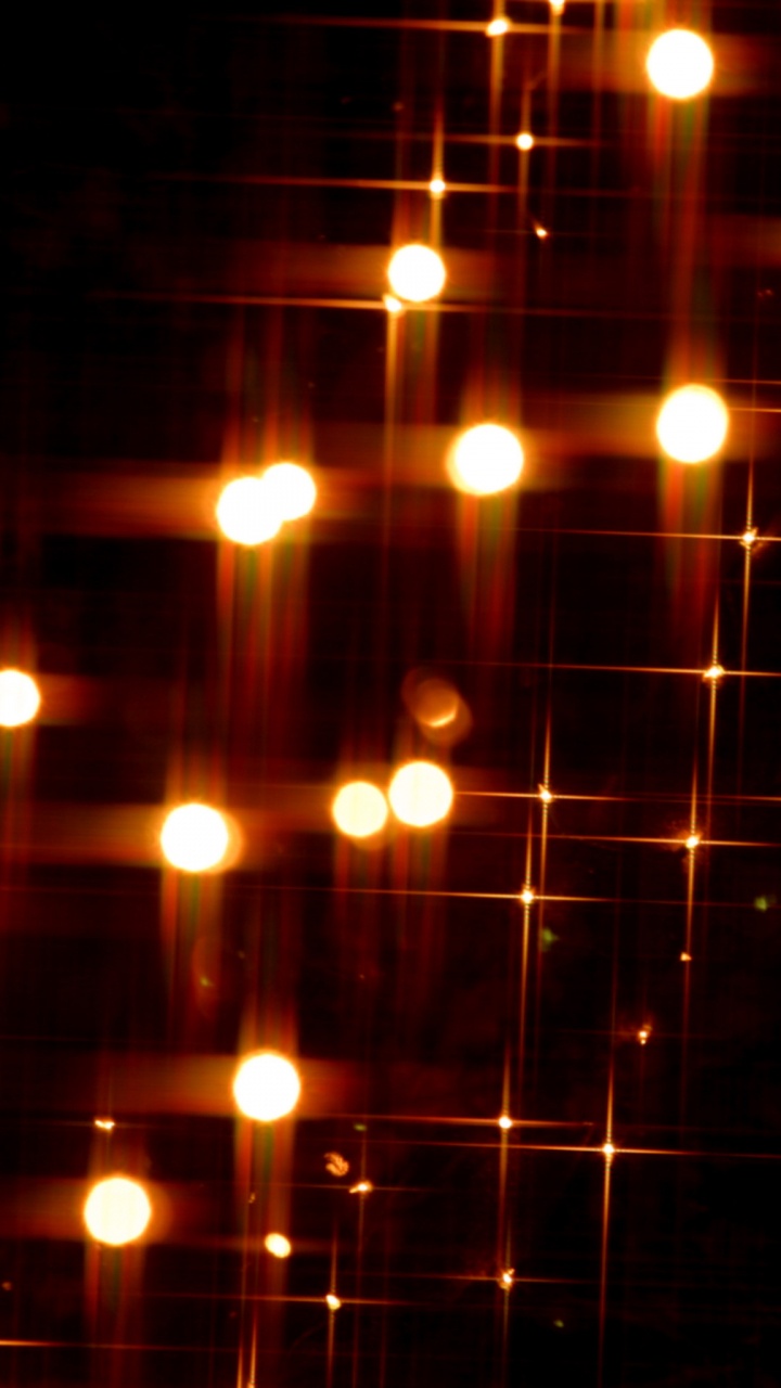 Orangefarbene Lichterketten Auf Schwarzem Hintergrund. Wallpaper in 720x1280 Resolution