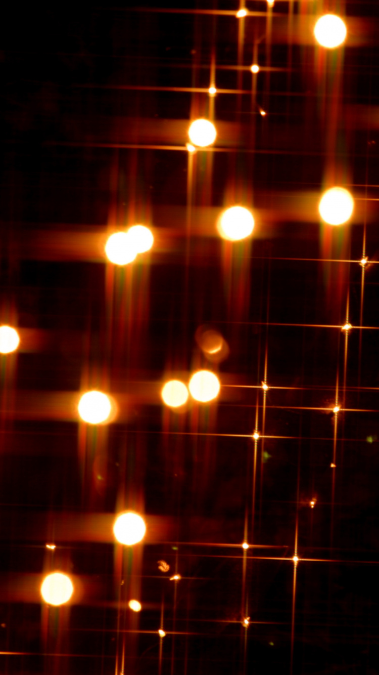 Orangefarbene Lichterketten Auf Schwarzem Hintergrund. Wallpaper in 750x1334 Resolution