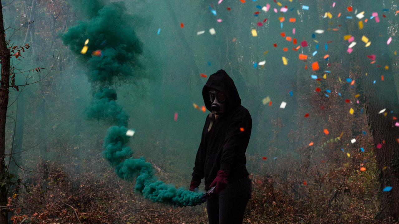 Woman in Black Jacket Standing Under Green and Pink String Lights. Wallpaper in 1280x720 Resolution