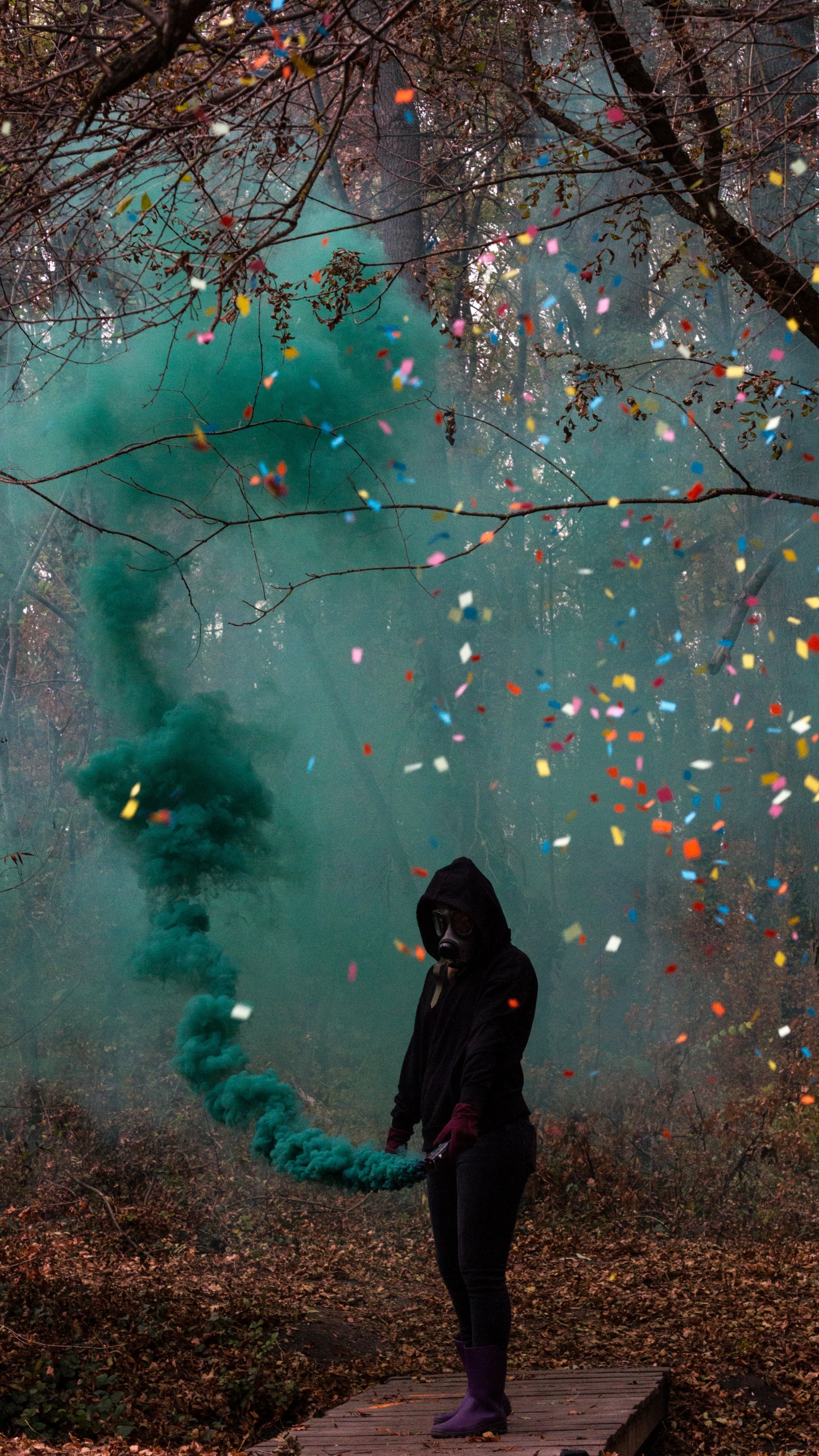 Woman in Black Jacket Standing Under Green and Pink String Lights. Wallpaper in 1440x2560 Resolution
