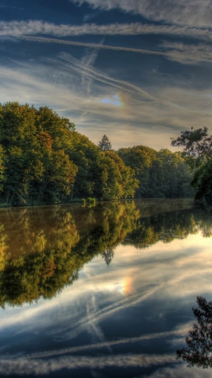 Green Trees Beside River Under Blue Sky During Daytime. Wallpaper in 720x1280 Resolution