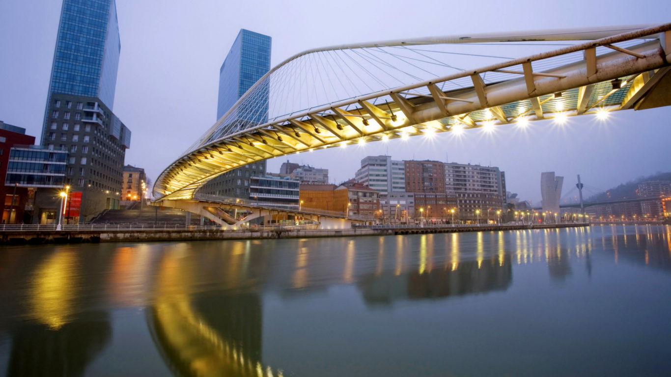 Bridge Over Water Near City Buildings During Night Time. Wallpaper in 1366x768 Resolution
