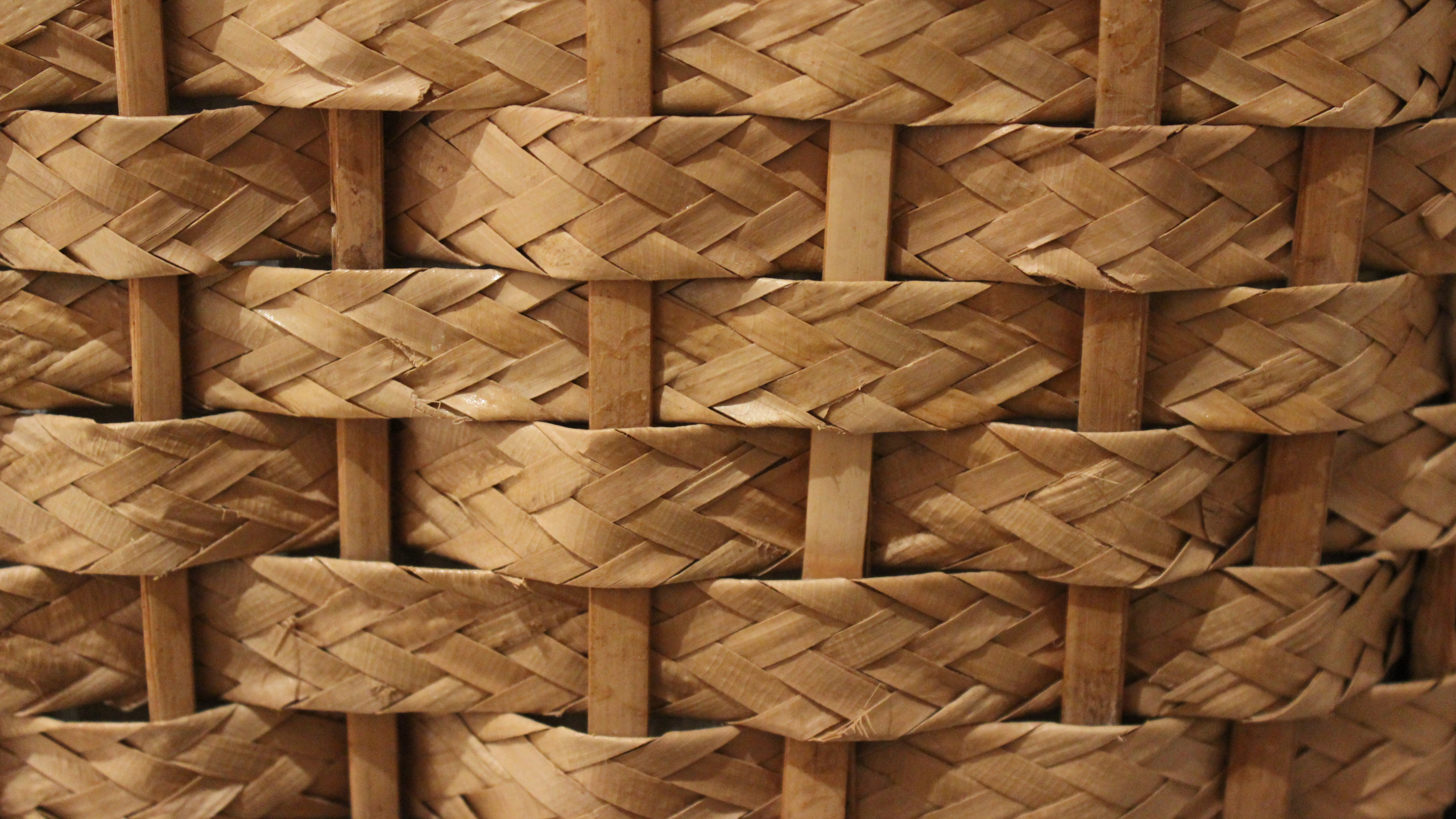 Brown Woven Basket on White Textile. Wallpaper in 2560x1440 Resolution