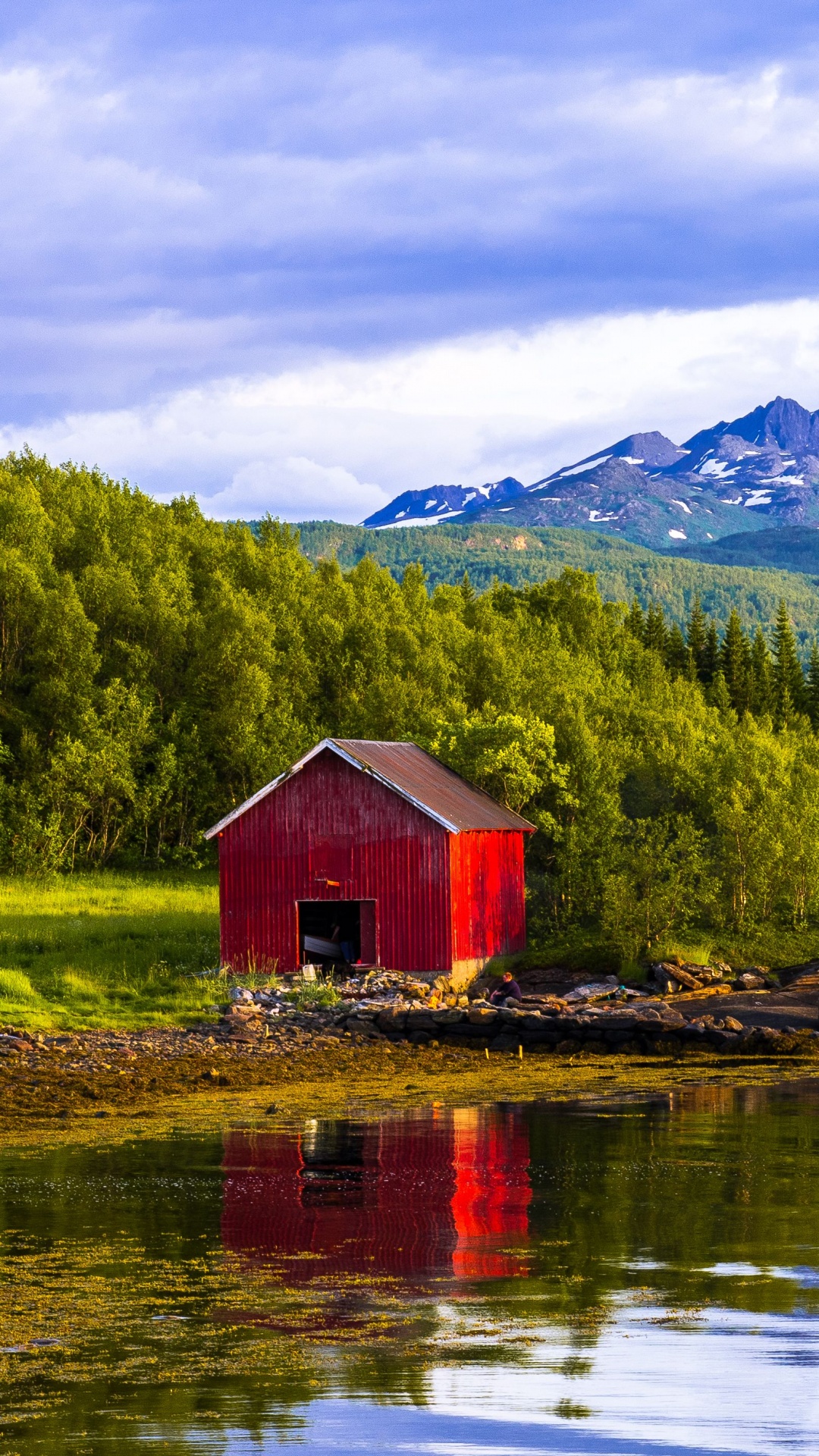 Brown Wooden House on Lake Near Green Trees and Mountain Under White Clouds and Blue Sky. Wallpaper in 1080x1920 Resolution
