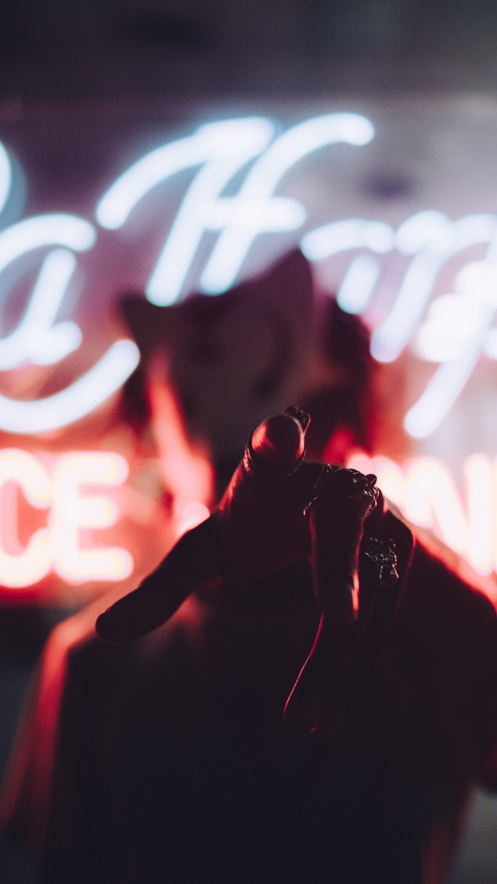 Download 720x1280 Wallpaper Person in Red Jacket Standing in Front of Red and White Neon Light Signage Person in Red Jacket Standing in Front of Red and White Neon Light Signage. Wallpaper in 720x1280 Resolution