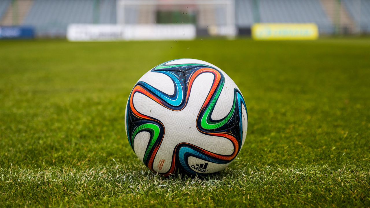 White Blue and Red Soccer Ball on Green Grass Field During Daytime. Wallpaper in 1280x720 Resolution