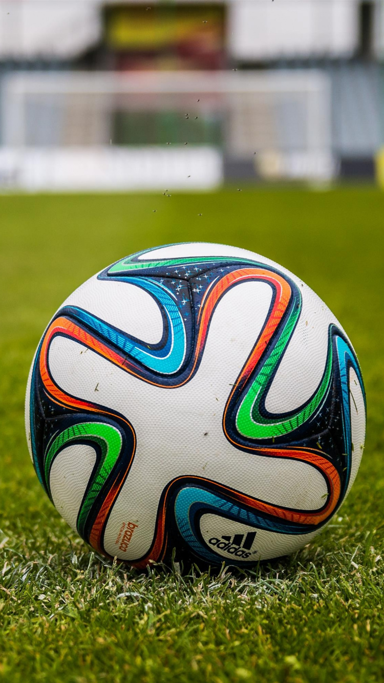 White Blue and Red Soccer Ball on Green Grass Field During Daytime. Wallpaper in 750x1334 Resolution