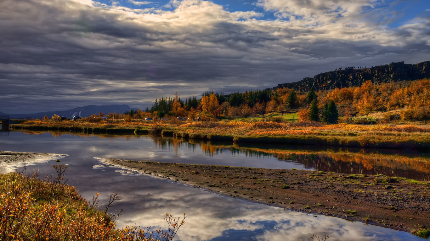 Brown and Green Trees Beside River Under White Clouds and Blue Sky During Daytime. Wallpaper in 1366x768 Resolution