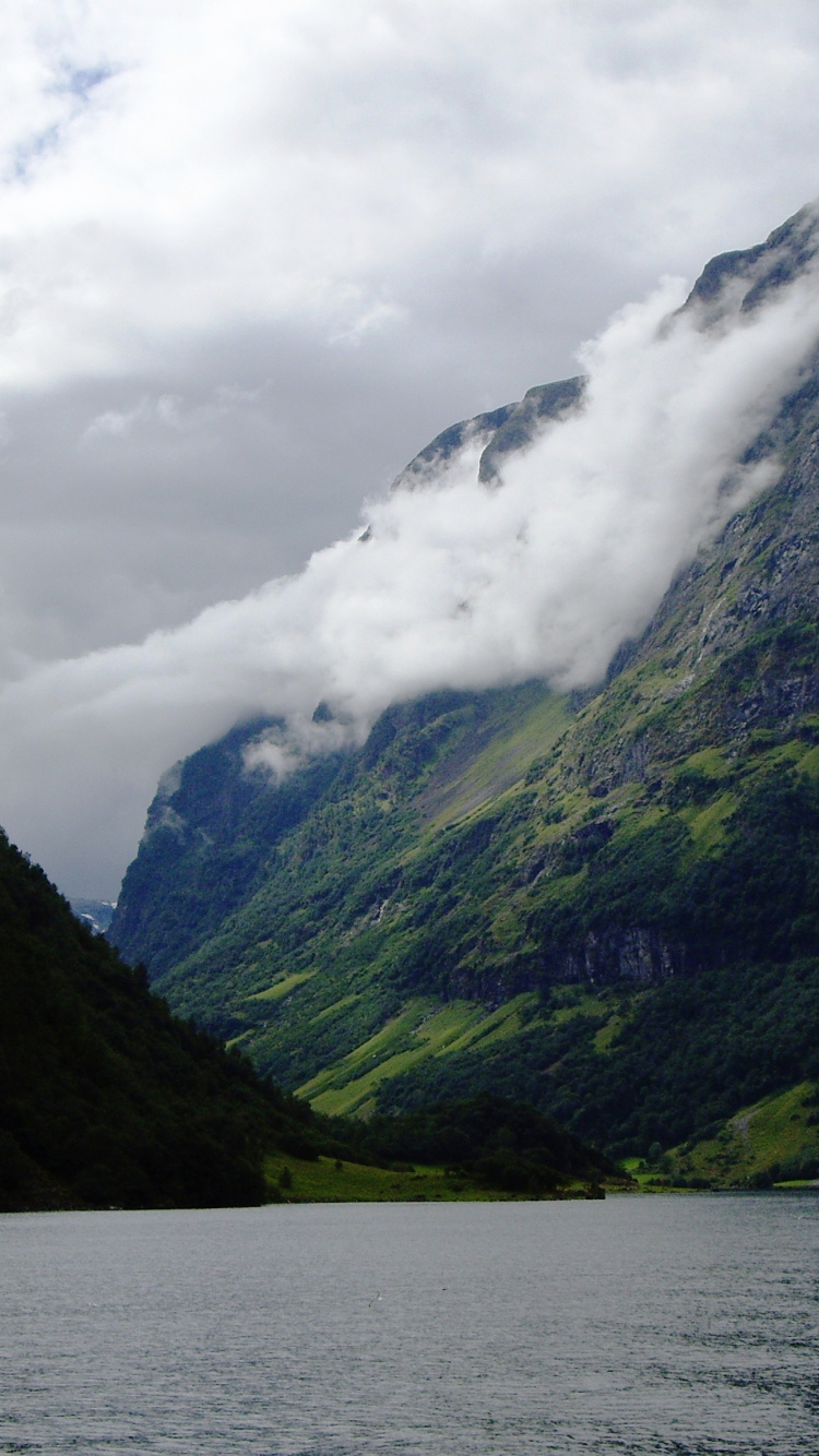 Body of Water Between Mountains Under Cloudy Sky During Daytime. Wallpaper in 750x1334 Resolution