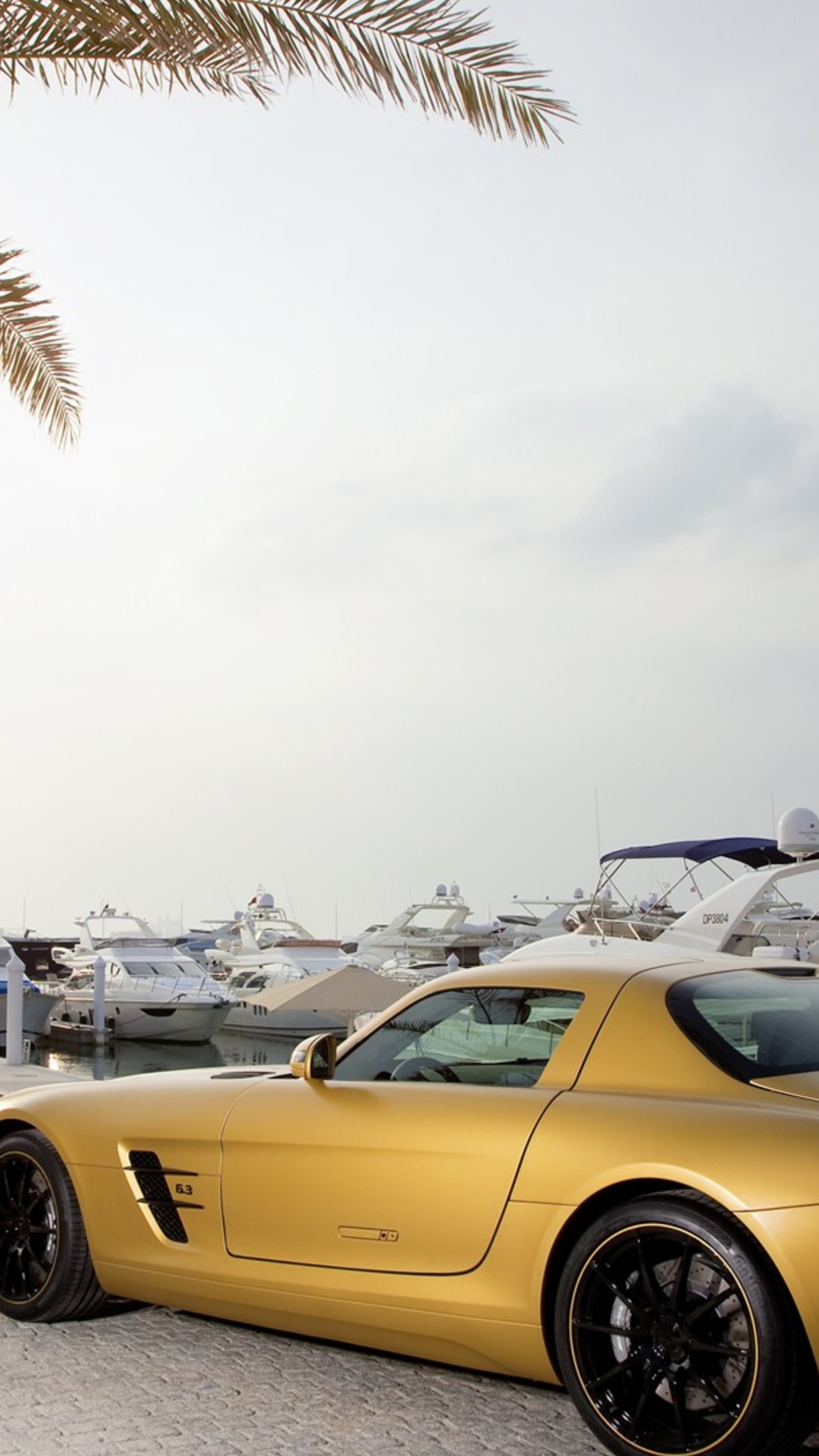 Yellow Porsche 911 Parked Near Palm Trees and Buildings During Daytime. Wallpaper in 1440x2560 Resolution
