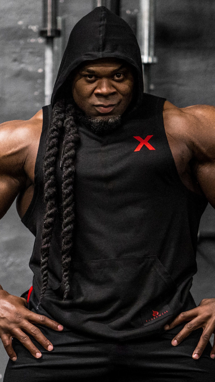 Mann in Schwarzem Tanktop Und Schwarzen Shorts. Wallpaper in 750x1334 Resolution