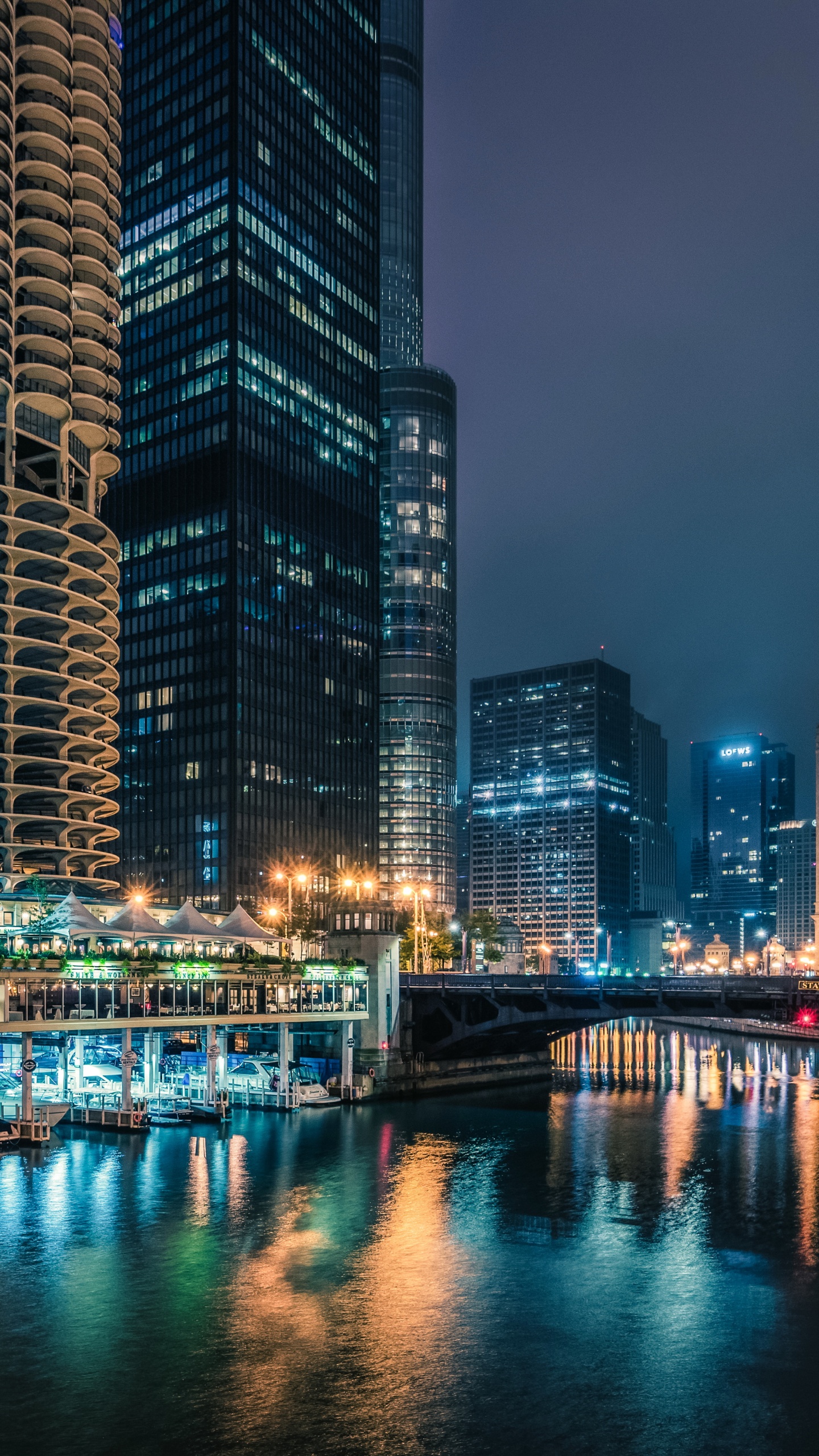 Body of Water Between High Rise Buildings During Night Time. Wallpaper in 1440x2560 Resolution