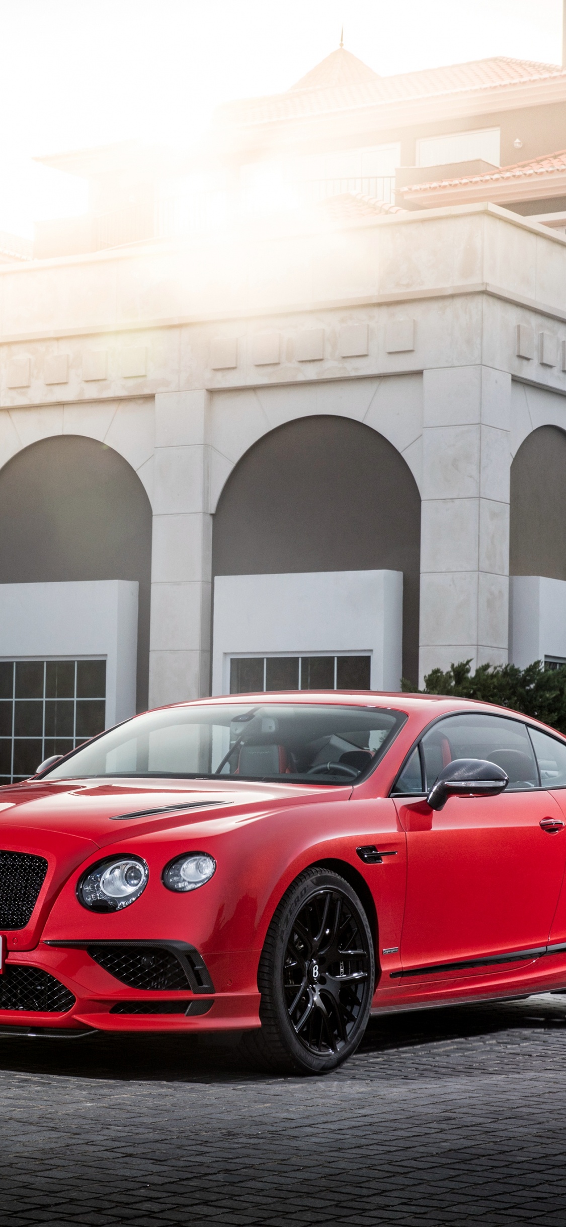 Red Bmw m 3 Coupe Parked Near Green Bush During Daytime. Wallpaper in 1125x2436 Resolution