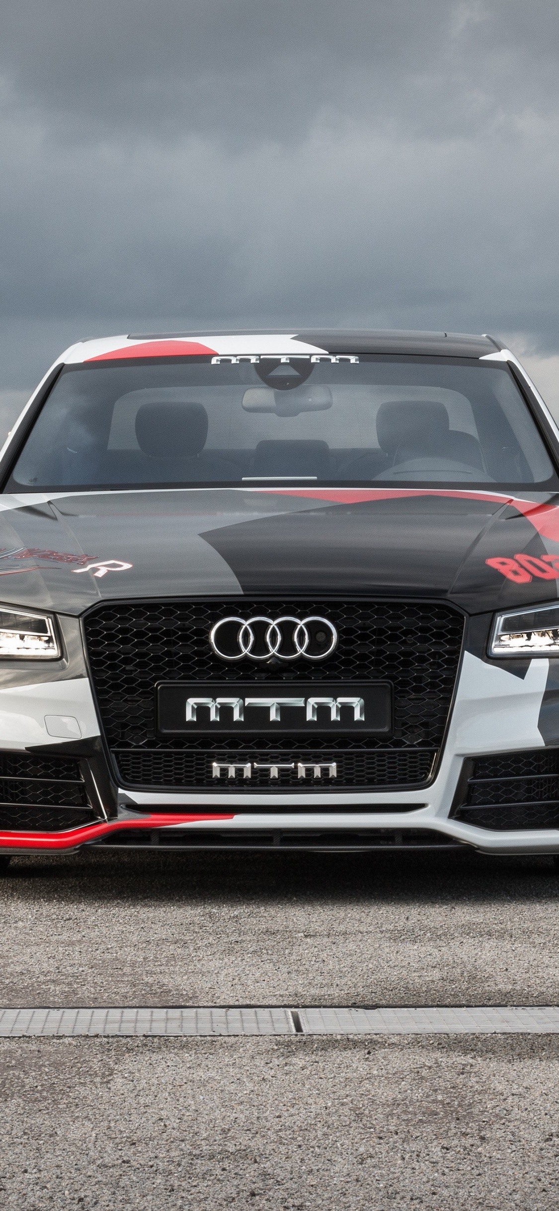 Black Audi a 4 on a Gray Asphalt Road. Wallpaper in 1125x2436 Resolution