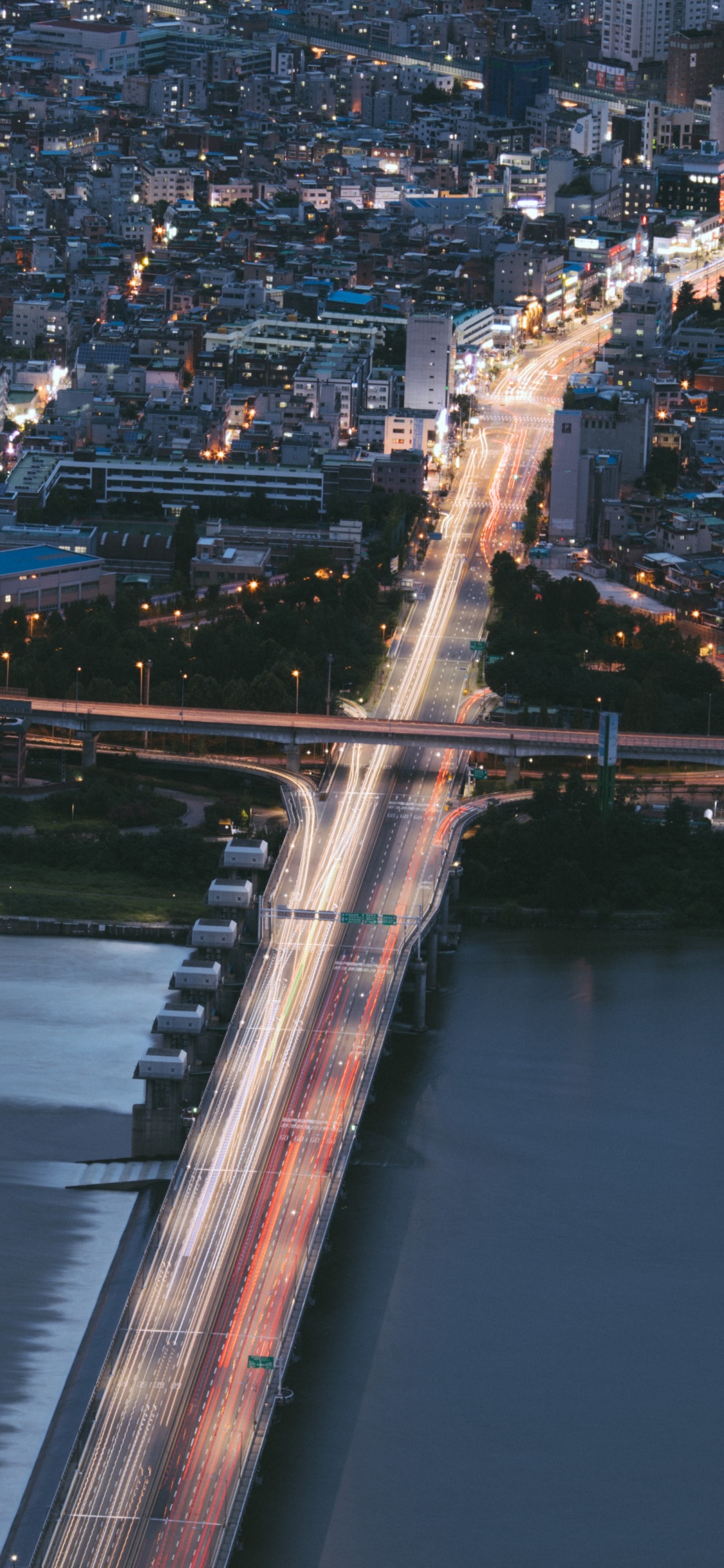 Aerial View of City Buildings During Night Time. Wallpaper in 1125x2436 Resolution