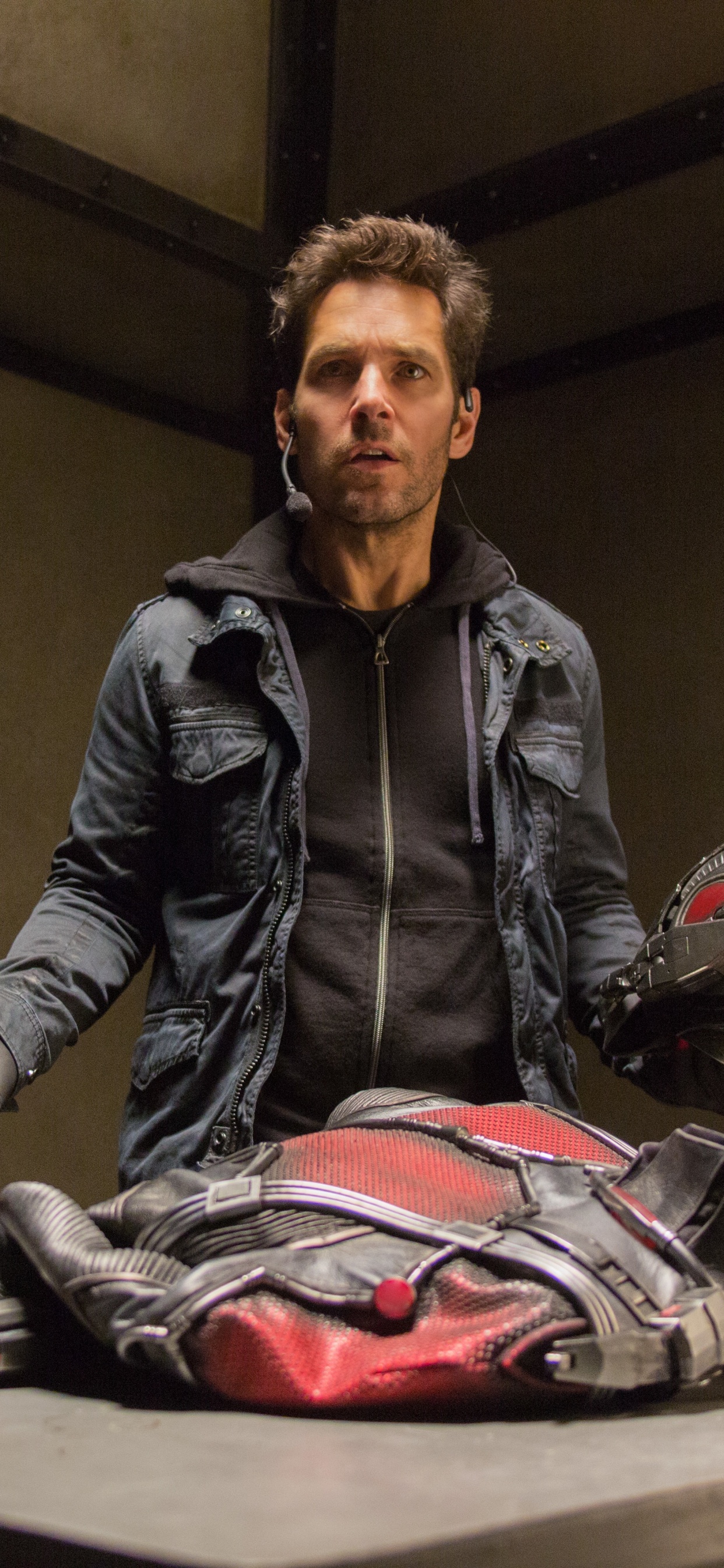 Man in Black Leather Jacket Sitting on Chair. Wallpaper in 1242x2688 Resolution