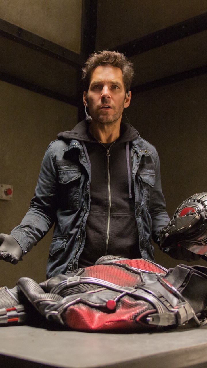 Man in Black Leather Jacket Sitting on Chair. Wallpaper in 720x1280 Resolution