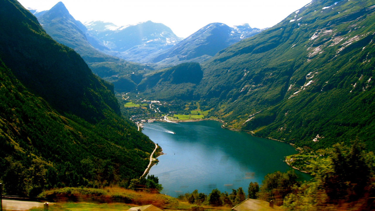 Green Mountains Near Lake Under White Sky During Daytime. Wallpaper in 1280x720 Resolution