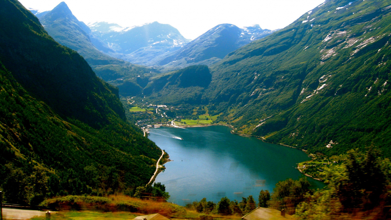 Green Mountains Near Lake Under White Sky During Daytime. Wallpaper in 1366x768 Resolution