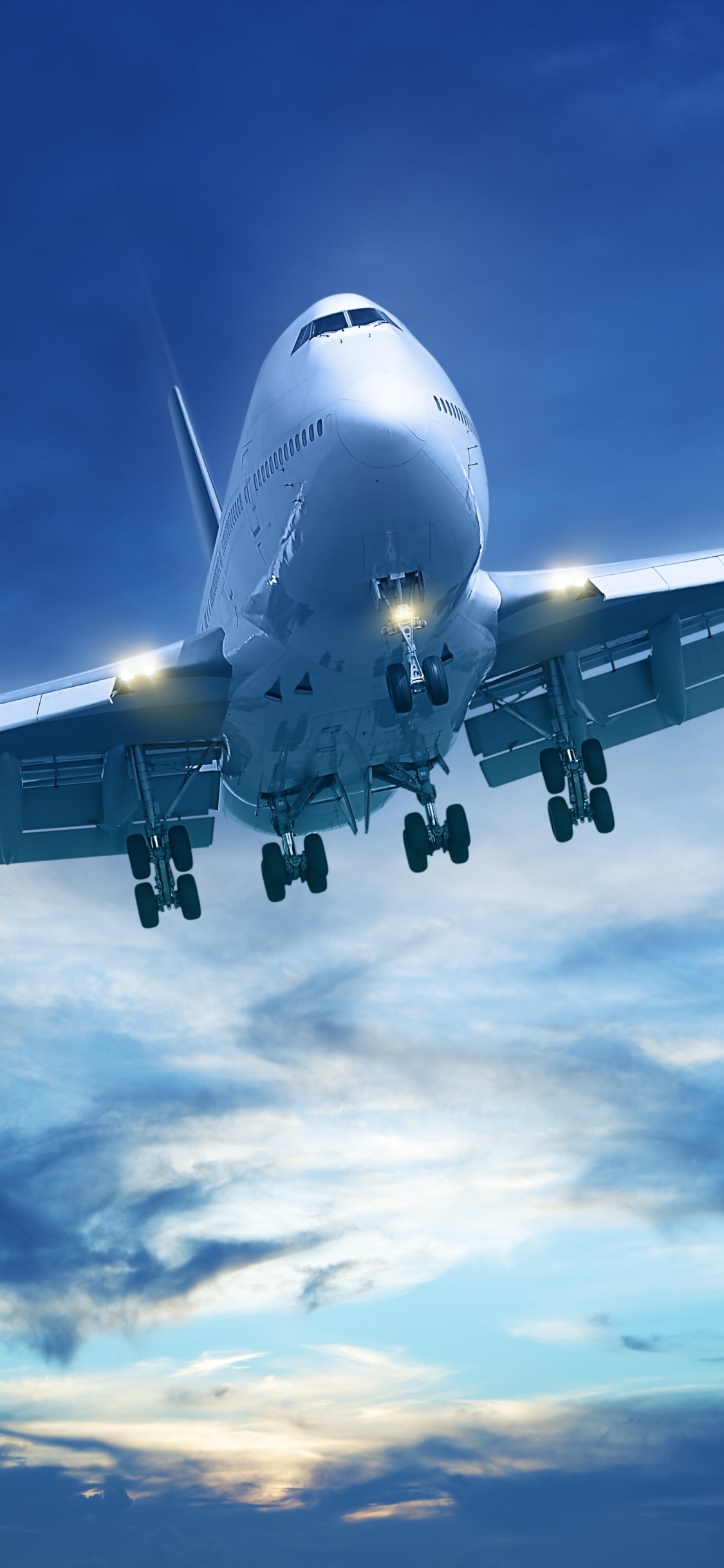 White Airplane Under Blue Sky During Daytime. Wallpaper in 1125x2436 Resolution