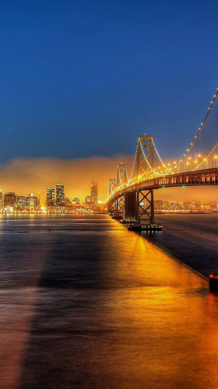 Bridge Over Water During Night Time. Wallpaper in 750x1334 Resolution
